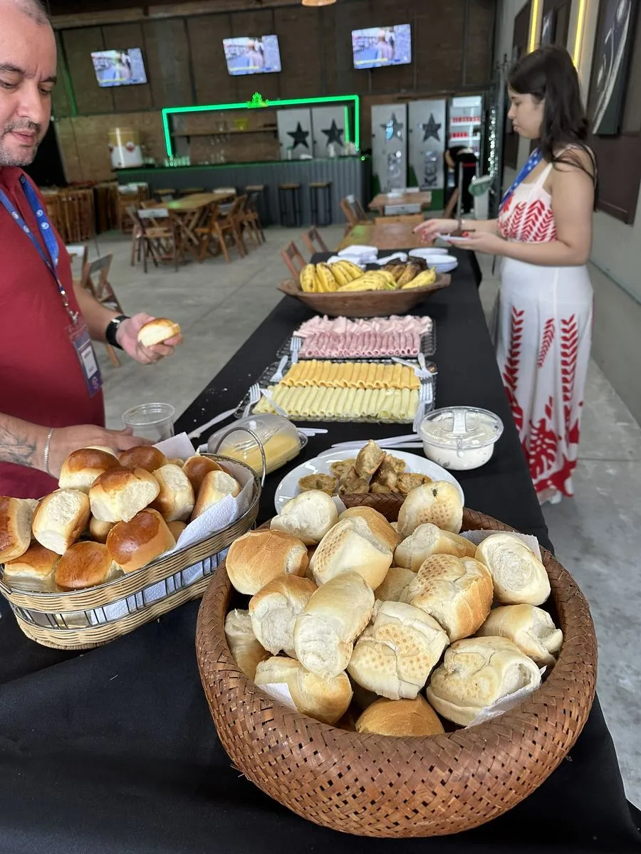 Mesa de café da manhã com pães, frios e frutas